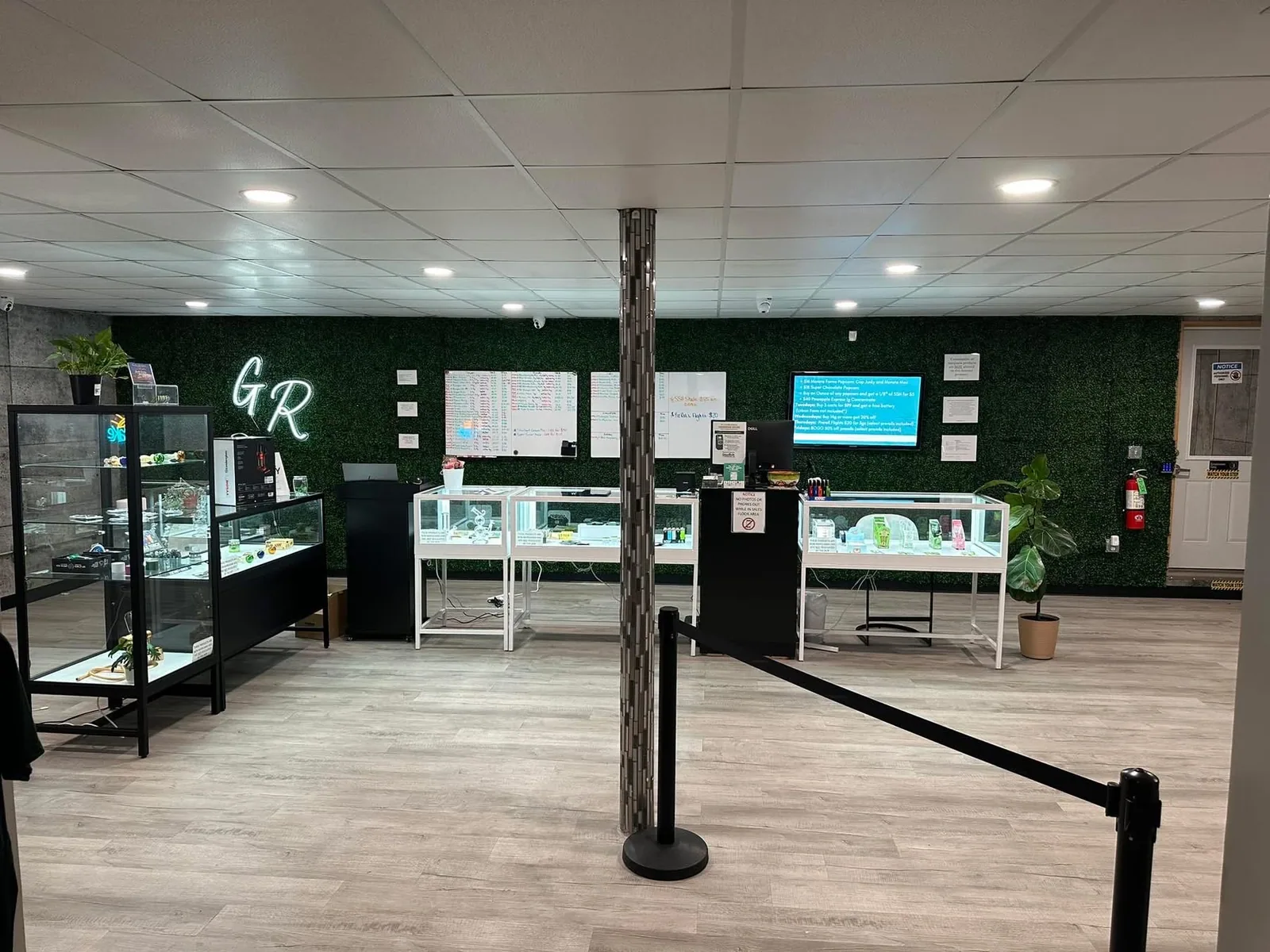 Glass displays and a green moss wall on the Grass Roots sales floor